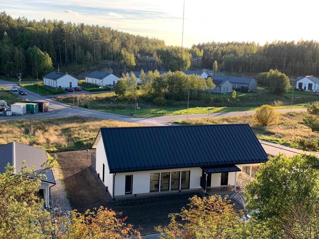 man and woman laughing while sitting in front of laptops