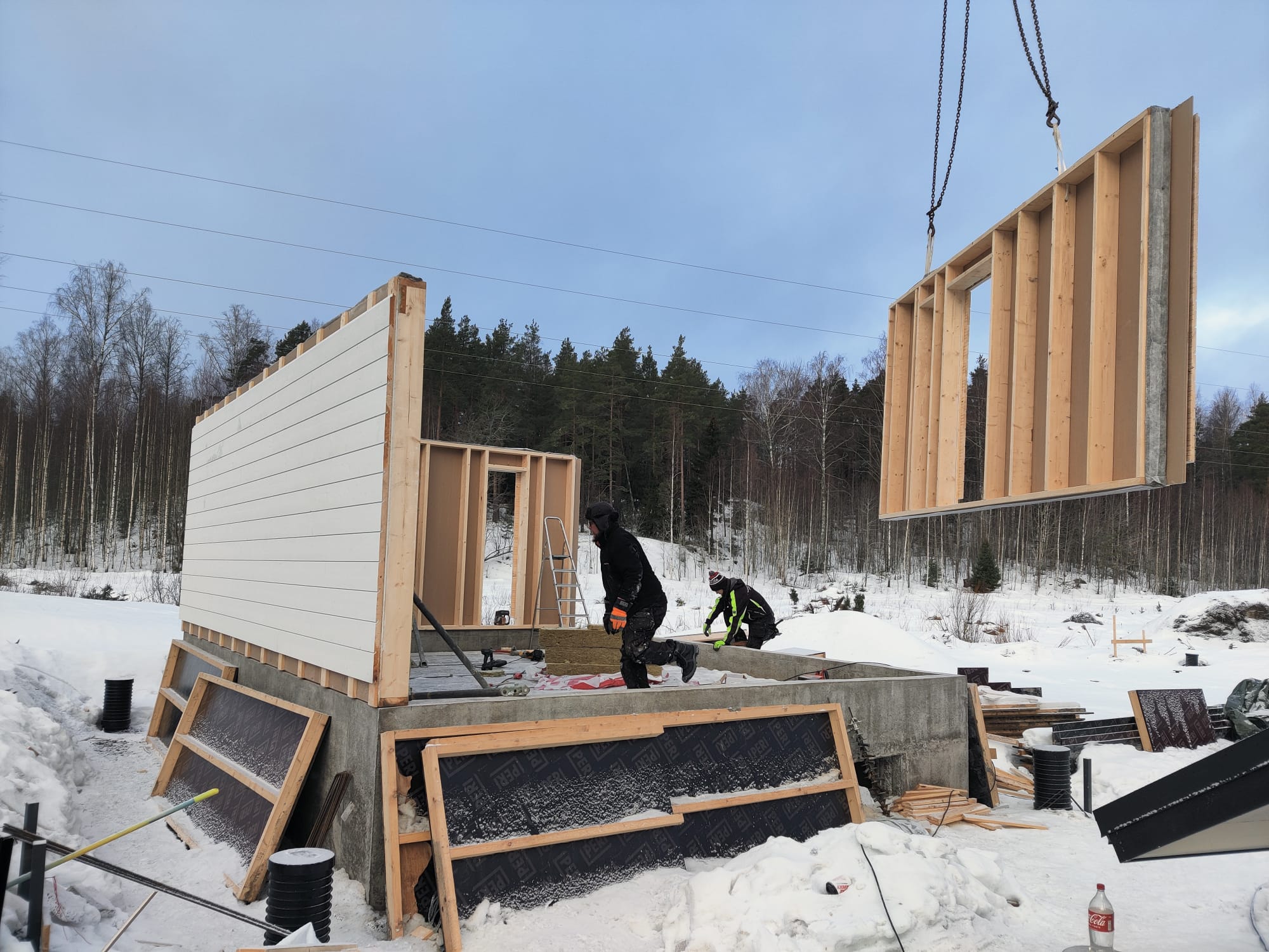 man and woman laughing while sitting in front of laptops