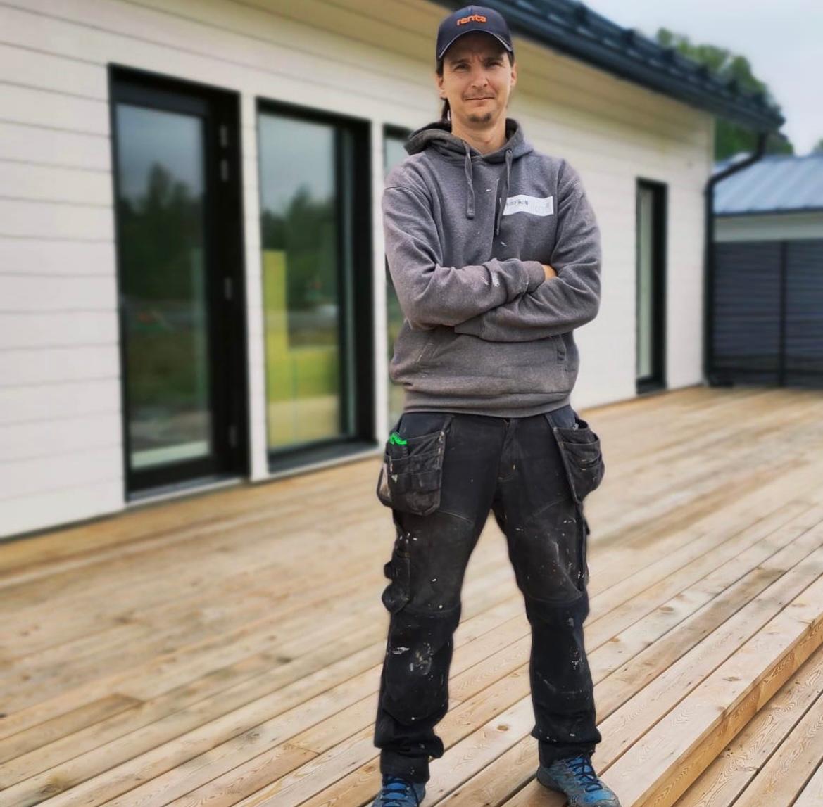 man and woman laughing while sitting in front of laptops
